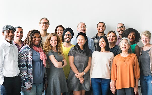 A work team of diverse individuals standing for a photo