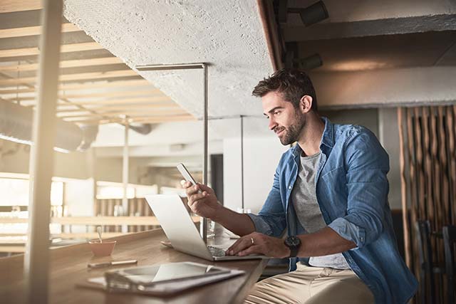 A young entrepreneur reading his emails in a modern office